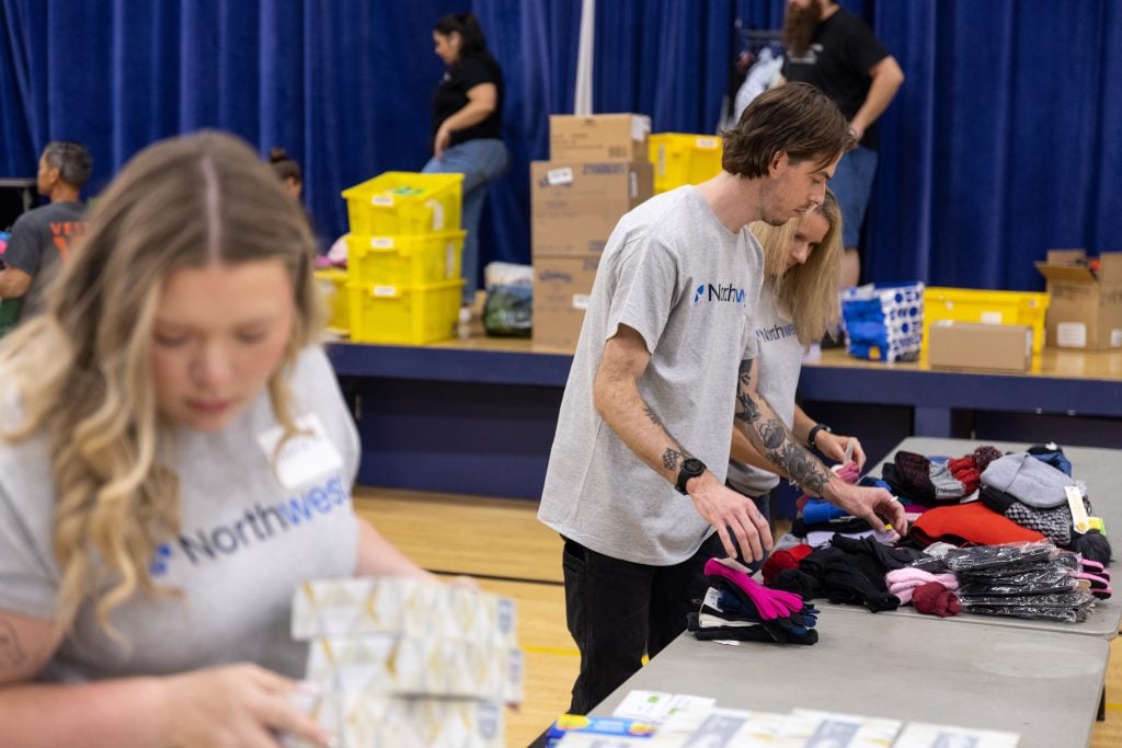 Two NWRA volunteers sorting school supplies.