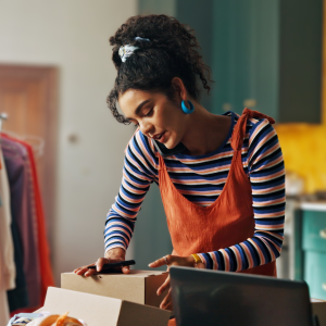 Woman on phone sorting through box of things