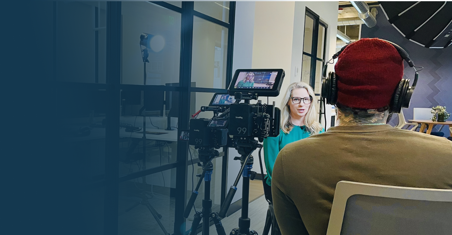 Interview for All Access offer with man in red hat and woman in front of camera